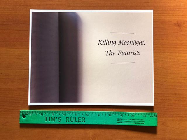 Image d'une photographie noir et blanc d'une double page d'un livre sur laquelle est écrit "Killing Moonlight : The Futurist" et d'une règle graduée verte sur laquelle est inscrit "Tim's ruler"